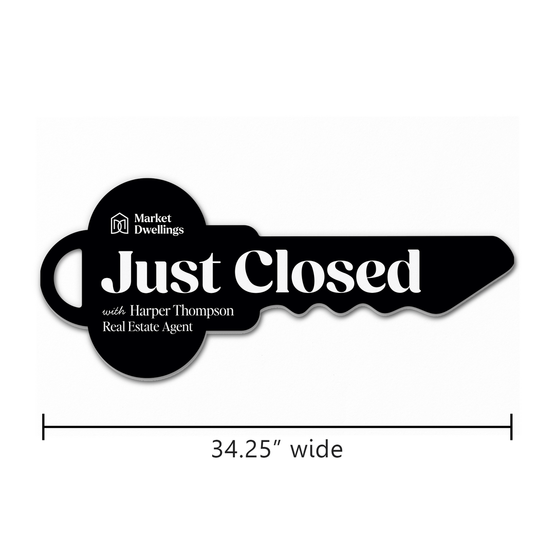 Black key-shaped sign with 'Just Closed' text and branding on a white background